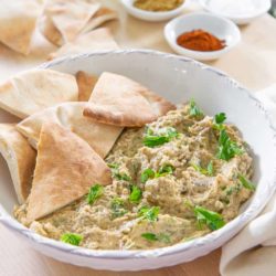 Baba Ganoush Served in a White Bowl with Pita Wedges