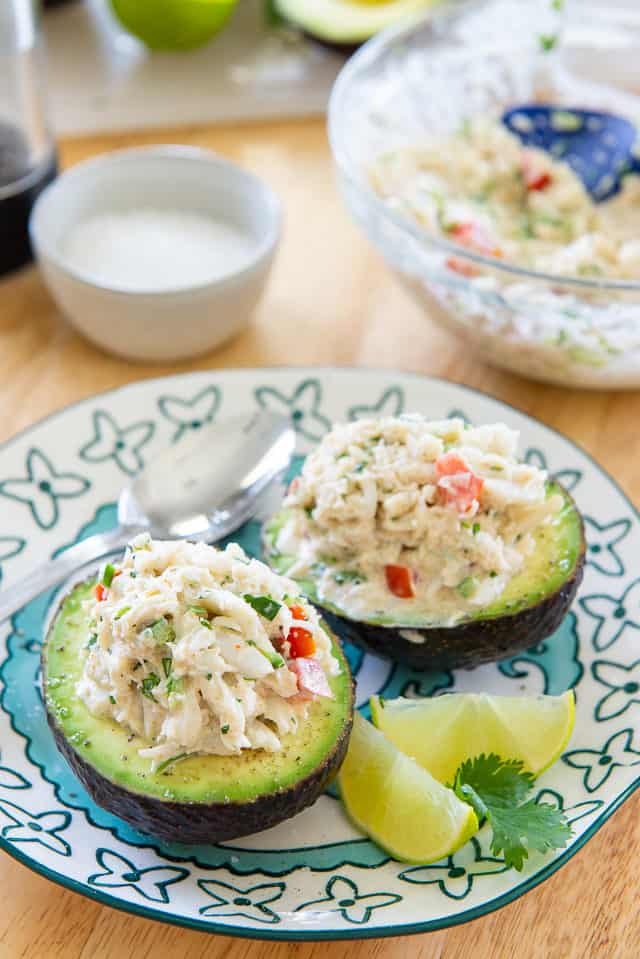 Crab Stuffed Avocado - Served on Blue Plate with Lemon Wedges 