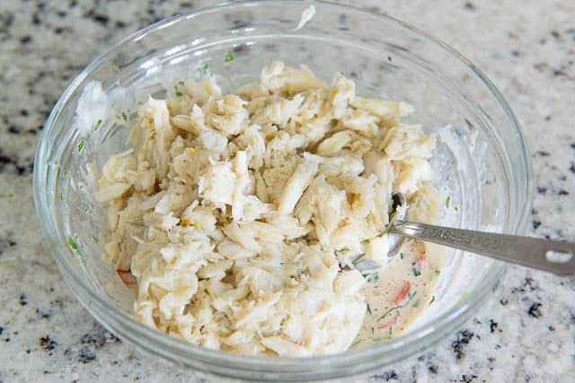 Blue Crab Meat Added to Glass Bowl with Dressing