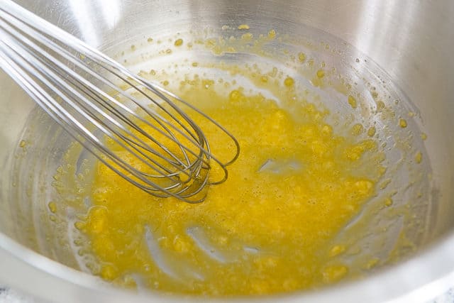 Aioli Recipe - Made from scratch with a bowl and a whisk with egg yolk