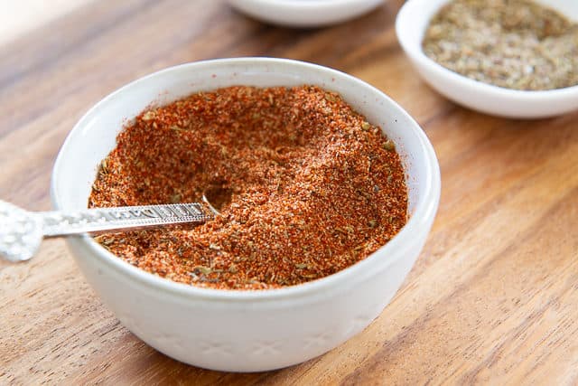 How to Make Cajun Seasoning - Piles of Spices Now Stirred Together for Cohesive Spice Mix with Metal Teaspoon