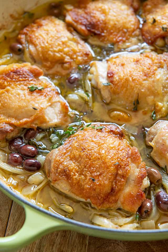 Braised Chicken Thighs Recipe - Served in light Green Braiser with Olives and Fennel