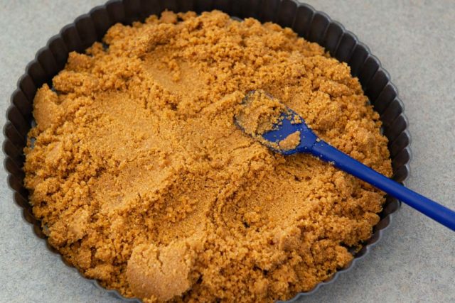 How to Make Graham Cracker Crust by Pressing Crumbs Into the Pan with Spatula