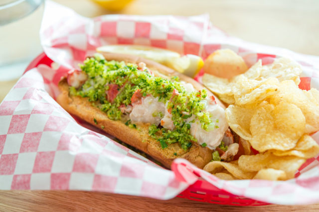 Fresh Lobster Roll in Paper with Chips in Basket
