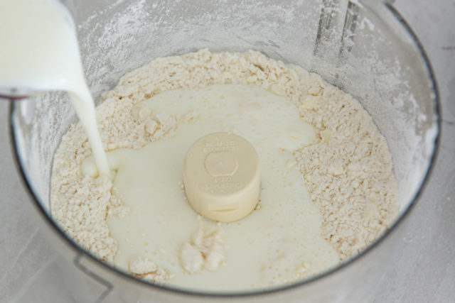 Pouring Buttermilk Into Food Processor Bowl 