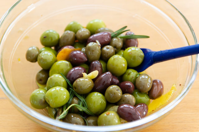 Marinated Olives Recipe - Presented in Glass Bowl with Rosemary and Garlic