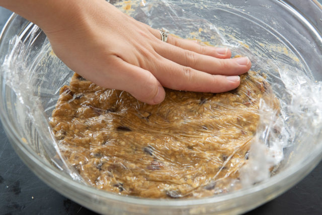 Pressing Plastic Wrap Onto Surface of the Oatmeal Chocolate Chip Cookie Dough