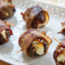 Bacon Wrapped Dates on a White Platter