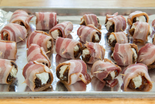 Bacon Wrapped Stuffed Dates Ready to Bake on Foil Lined Tray