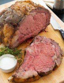 Prime Rib - Sliced and Standing on a Wooden Board