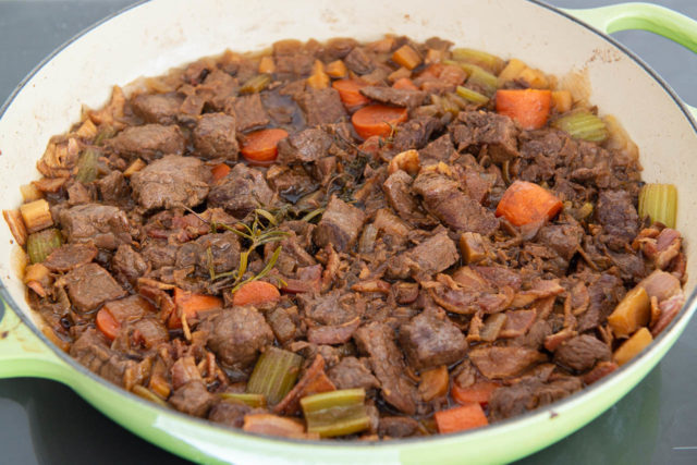 Easy Beef Stew Recipe - Plated in a Green Enamel Pan with Herbs