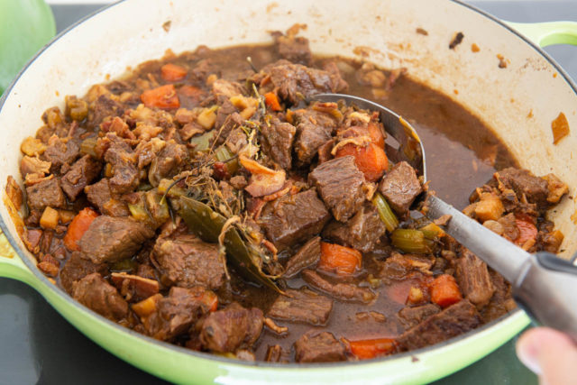 Best Beef Stew Recipe - Shown in Green Enamel Pan with Liquid