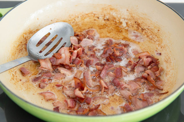Cooked crumbled Bacon in Green Enamel Pan