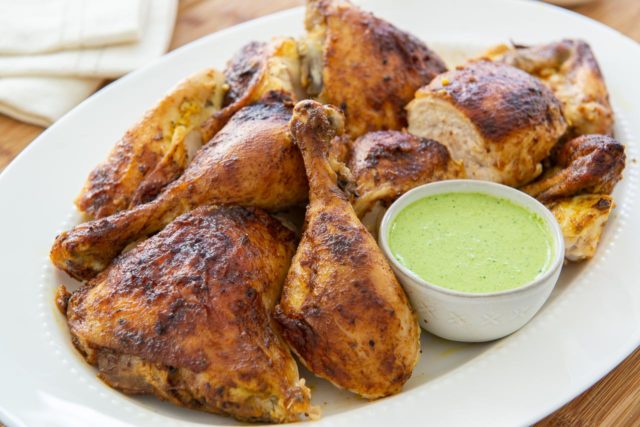 Peruvian Roasted Chicken - Cut Up and Plated with Fresh Green Sauce