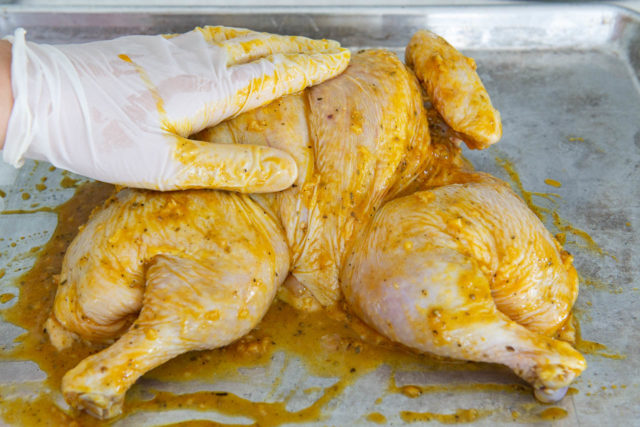 Rubbing the Aji Amarillo Paste Marinade On the Chicken