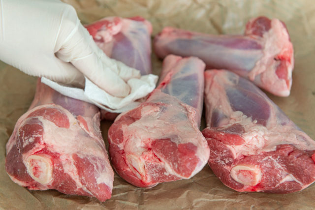 Patting Lamb Shank Dry with Paper Towel Before Searing