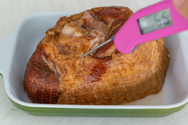 Placing the Meat in a Casserole Dish and Showing Warmed Temperature with Thermometer