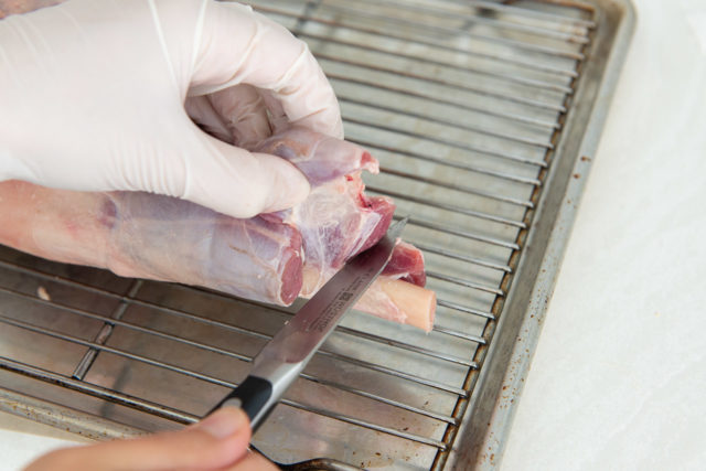 Pulling the Meat Away from the Bone Using Hand and paring Knife