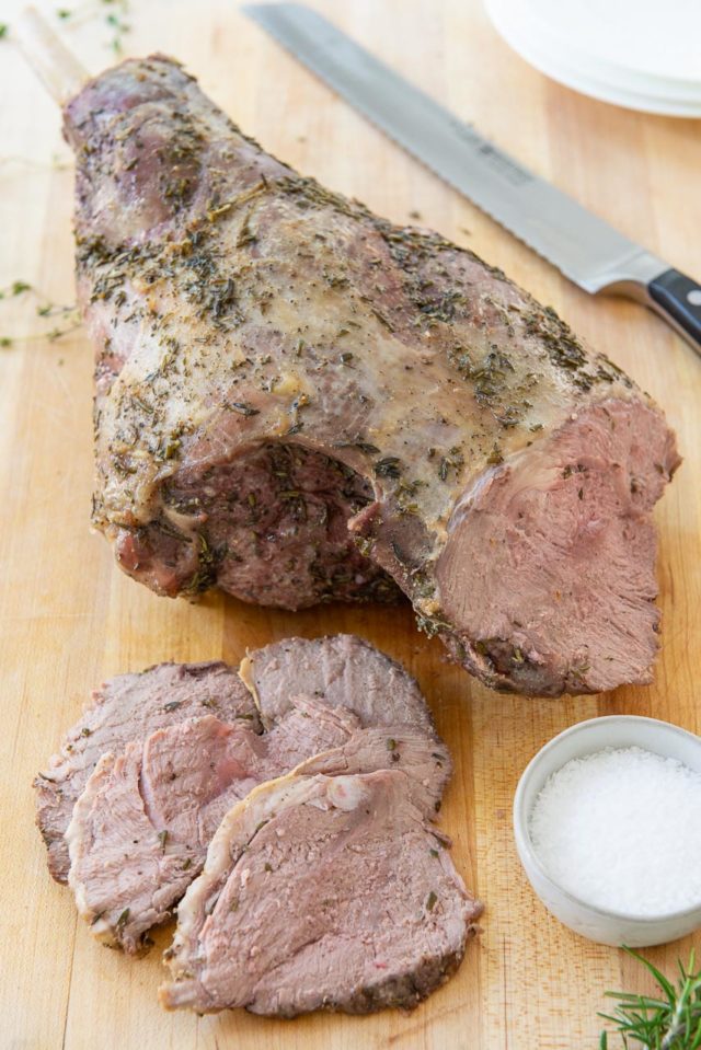Leg of Lamb - Sliced and Laying on a Wooden Board