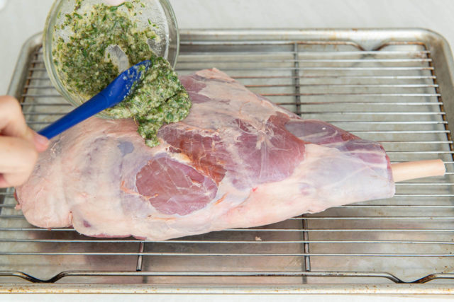 Pouring the Herb Ghee On a Frenched Leg of Lamb