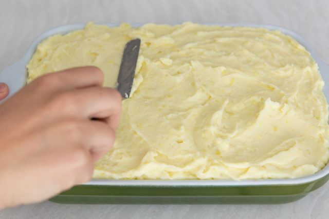 Spreading the Mashed Potato Layer in Casserole Dish with Offset Spatula