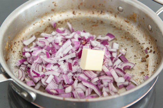 chopped red onion, butter, and salt in a stainless steel skillet