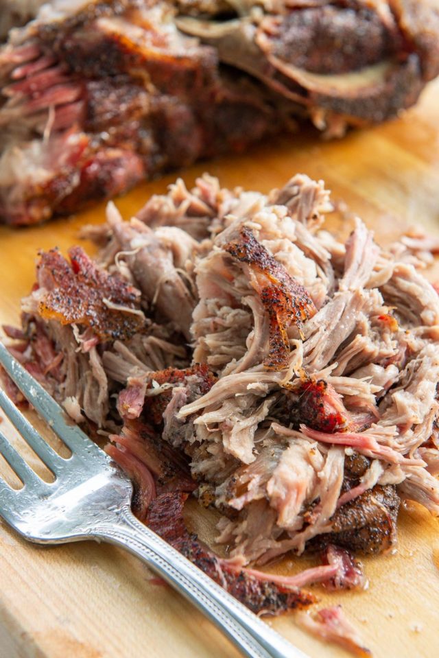 Smoked Pork Shoulder - Shredded in a Pile on Wooden Board with Fork