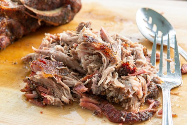 Smoked Pulled Pork - On a Wooden Board with Serving Fork