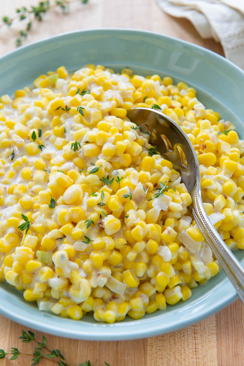 Creamed Corn - In a Blue bowl with Fresh Thyme on Top
