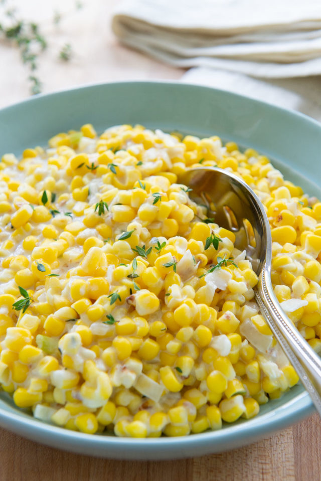 Cream Style Corn - in blue Dish with Fresh Thyme On Top
