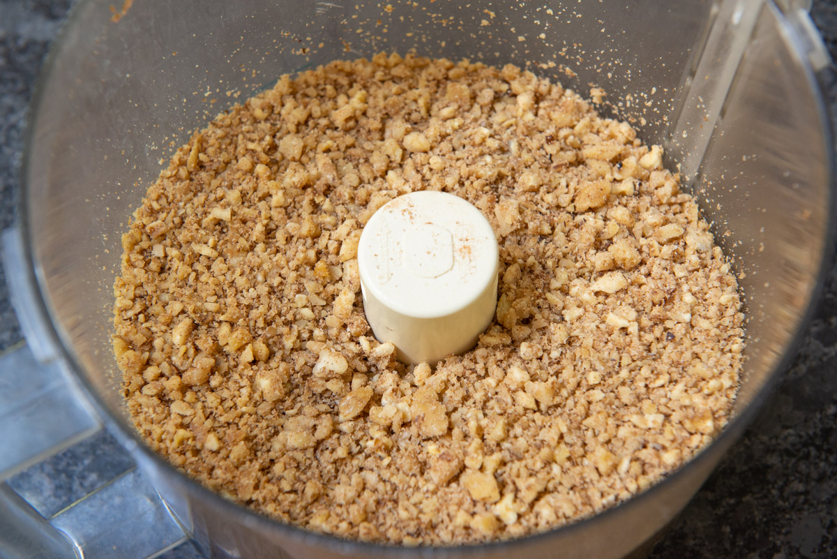 Baklava Ingredients Ground Up in Food Processor Bowl with Spiced walnuts
