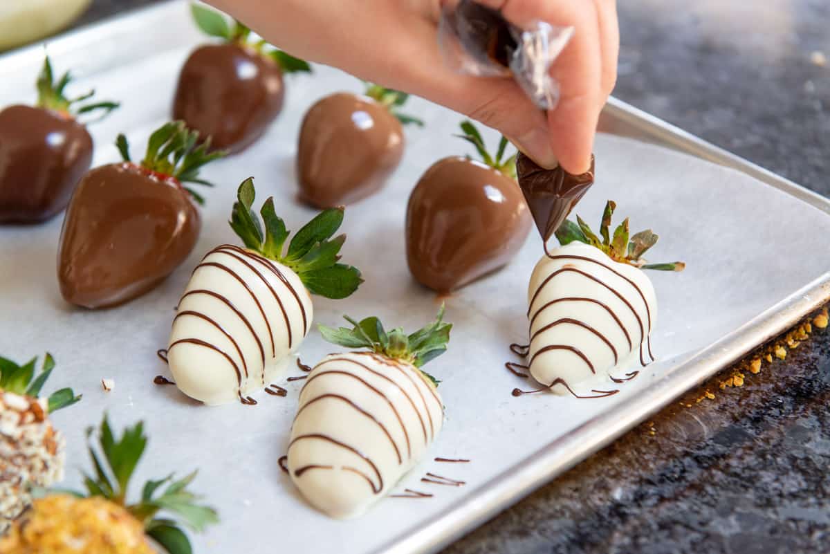 Chocolate Dipped Strawberries On Wax Paper Drizzling with Extra Chocolate