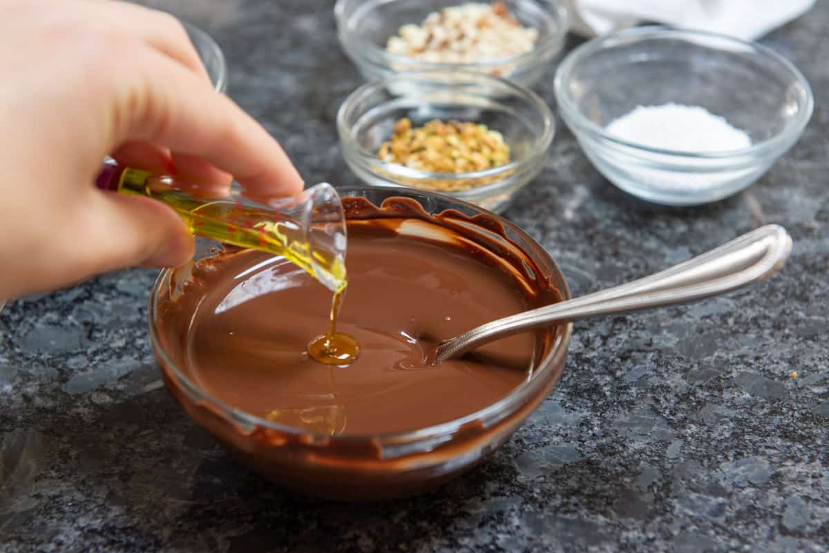 Pouring Oil Into Melted Chocolate to Loosen for Dipping