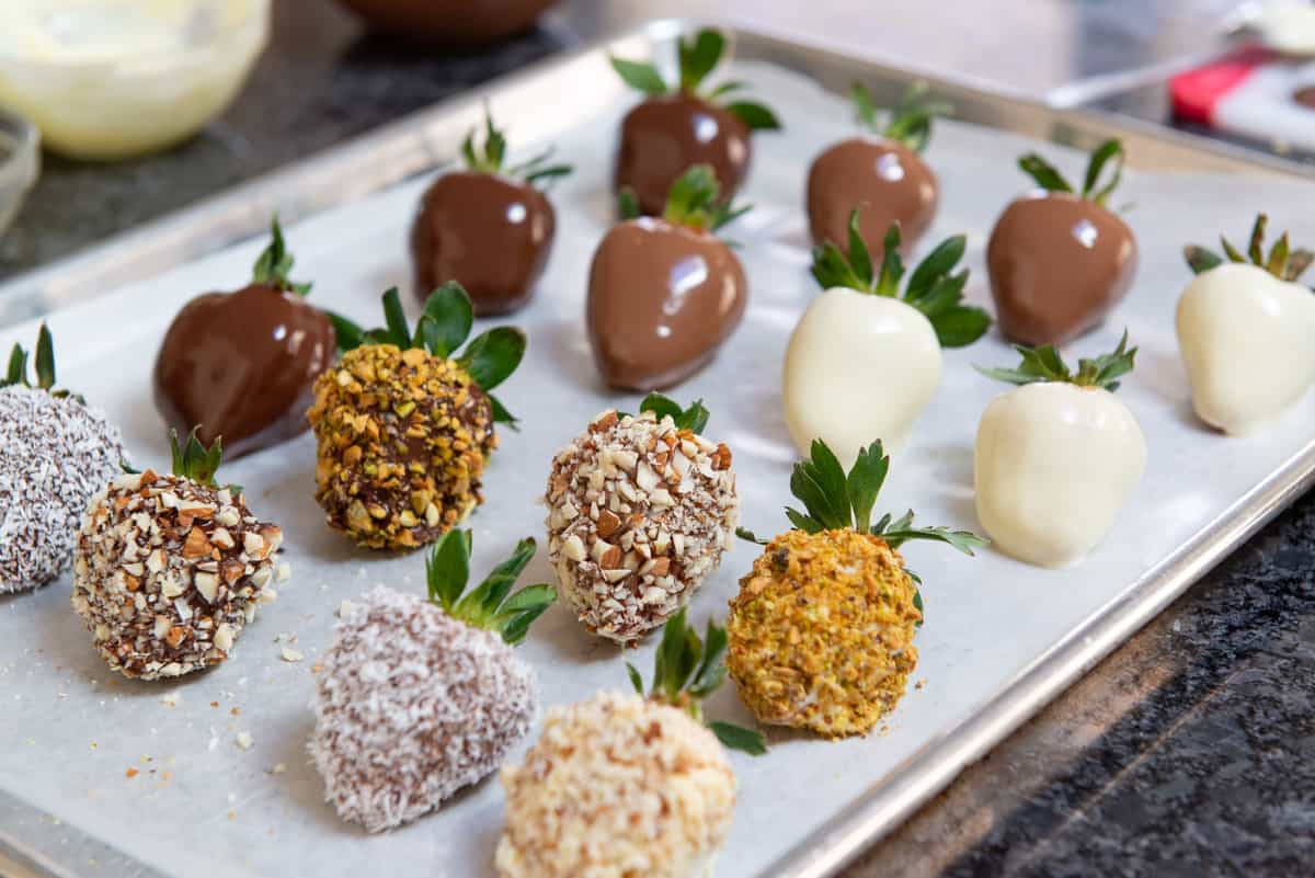 White Chocolate Covered Strawberries, Milk Chocolate Strawberries, on Wax Paper with Nuts and coconut