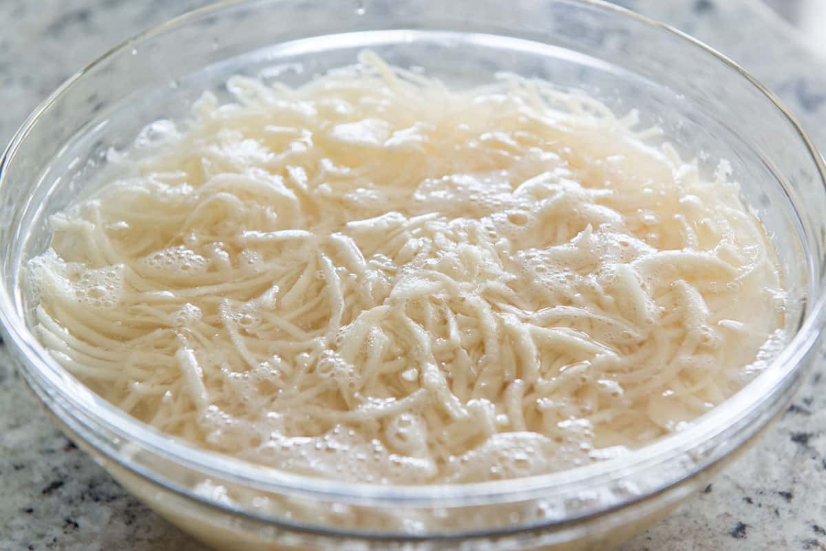 Soaked Shredded Russet Potatoes In Bowl