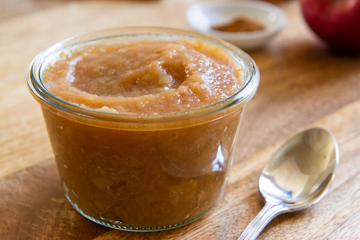 Homemade Applesauce in a Glass Jar on Wooden Board 