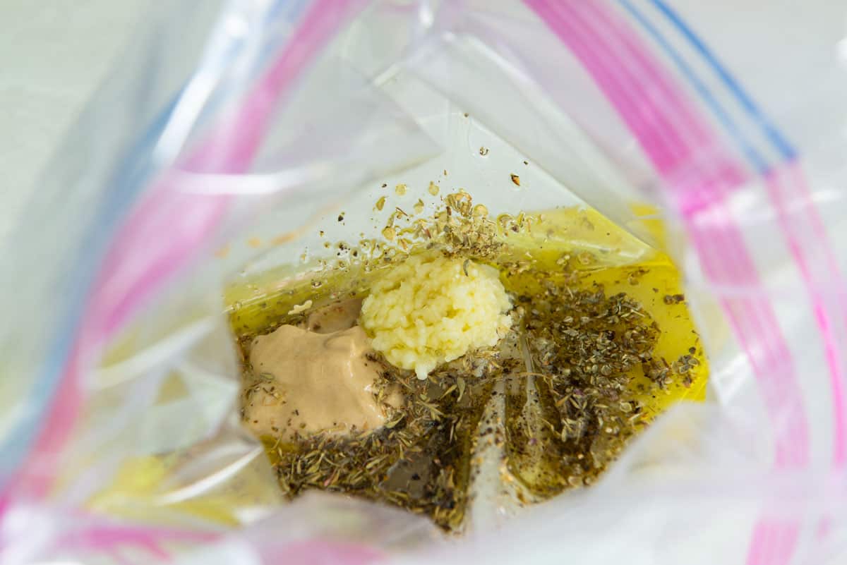 Olive Oil, Mustard, Lemon Juice, and Herbs in a Plastic Bag