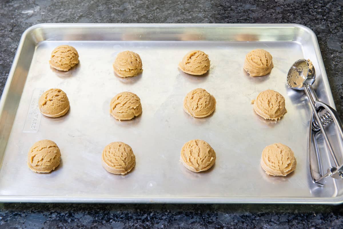 Scoops of Peanut Butter Cookie Dough on Sheet Pan