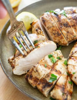 Grilled Chicken Breast Sliced On a Plate with Fork