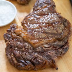 Grilled Ribeye Steak On Wooden Board with Salt