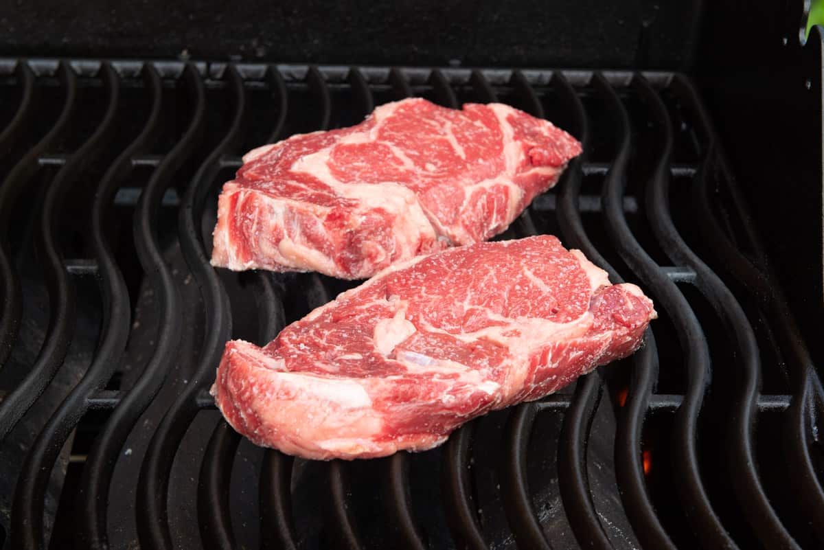Two Ribeyes On Grill Grates