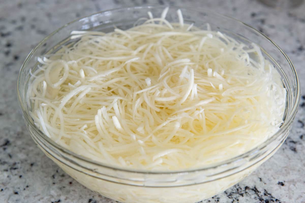 Soaking Shredded Potatoes in a Bowl to remove excess starch