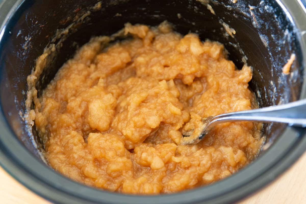 Mashed Applesauce in Crockpot Container with Fork