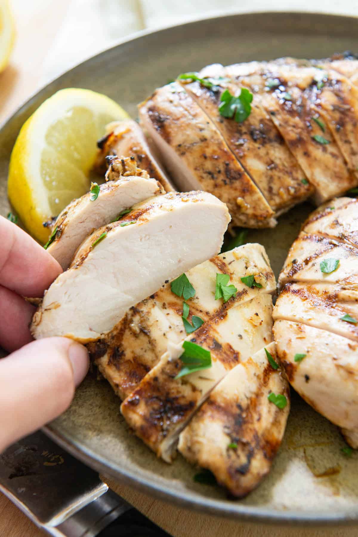 Juicy Sliced Grilled Chicken Breast On a Plate with Lemon
