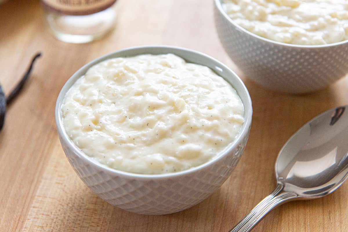 Easy Rice Pudding In Small blue Bowl with Spoon on Side 