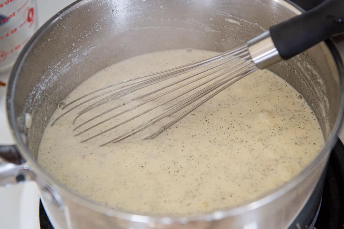 Rice Pudding Mixture Simmering in Pot with Whisk