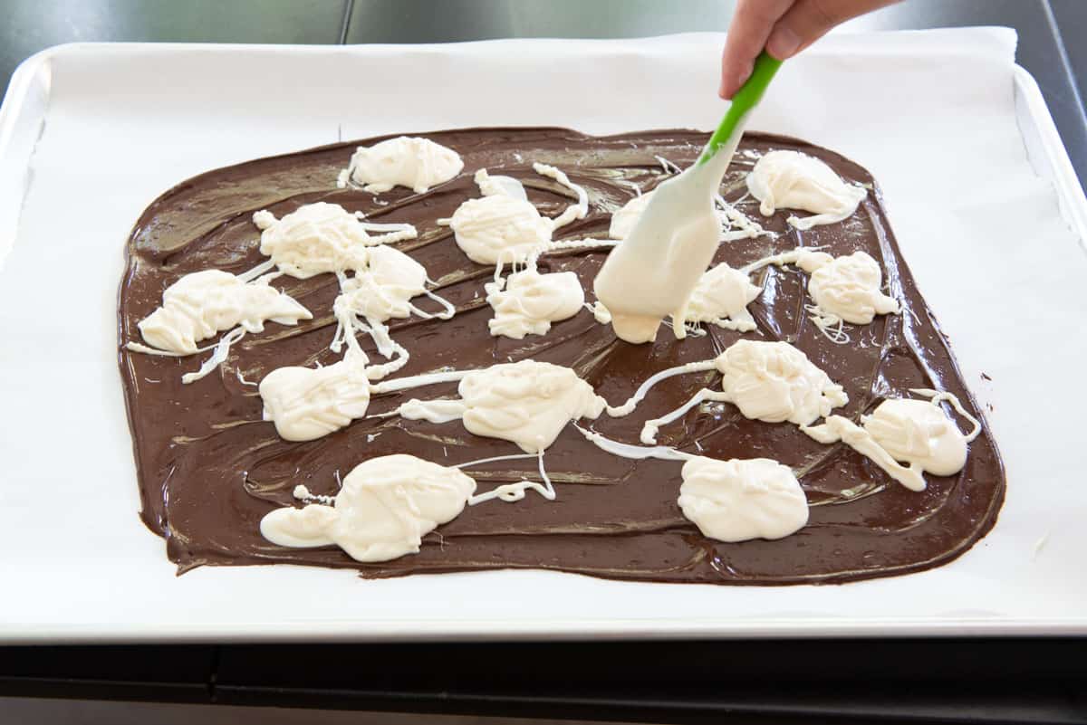 Adding Dollops of Melted White Chocolate to the Slab