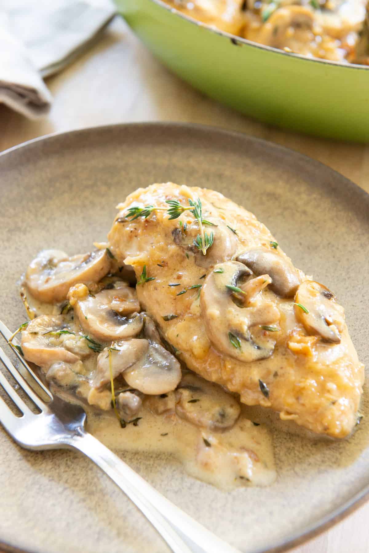 A Chicken Marsala Breast On Plate with Sauce and Mushrooms