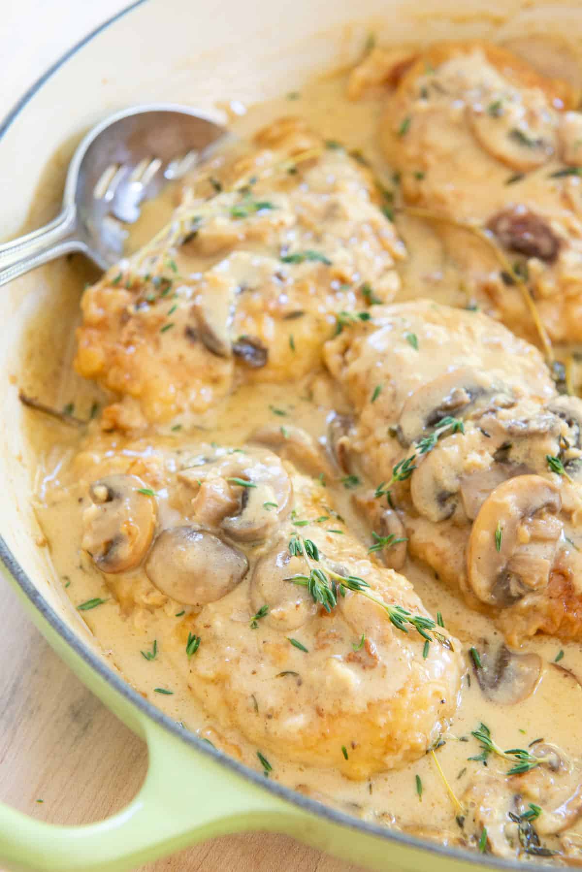 Chicken Marsala In a Green Dish with Spoon