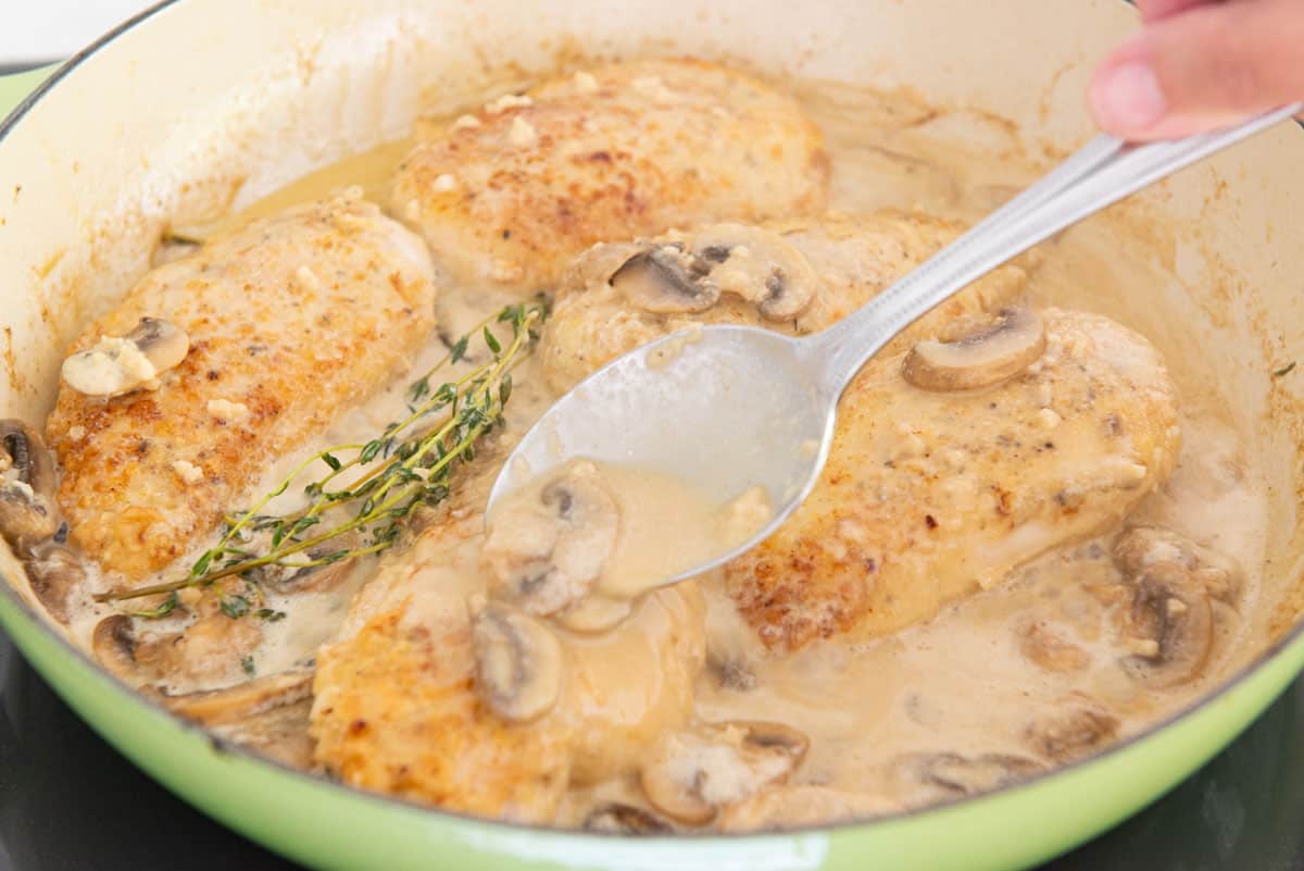 Spooning the Chicken Marsala Sauce Over the Chicken Breasts